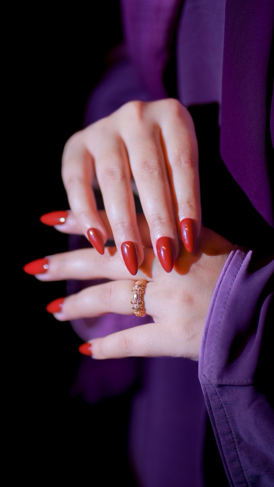 Glossy deep red bridal press-on gel nails with subtle crystal accents on both hands — dramatic Baraat night palette
